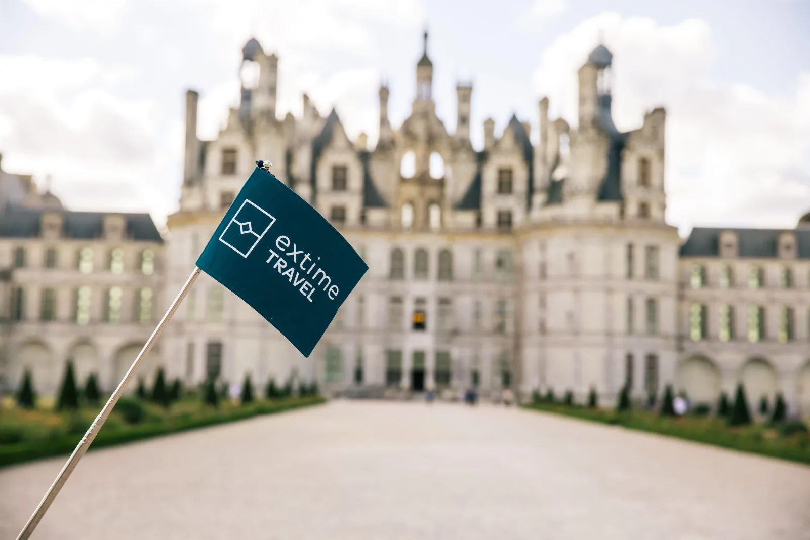 The operator's group flag raised in front of Château de Chambord
