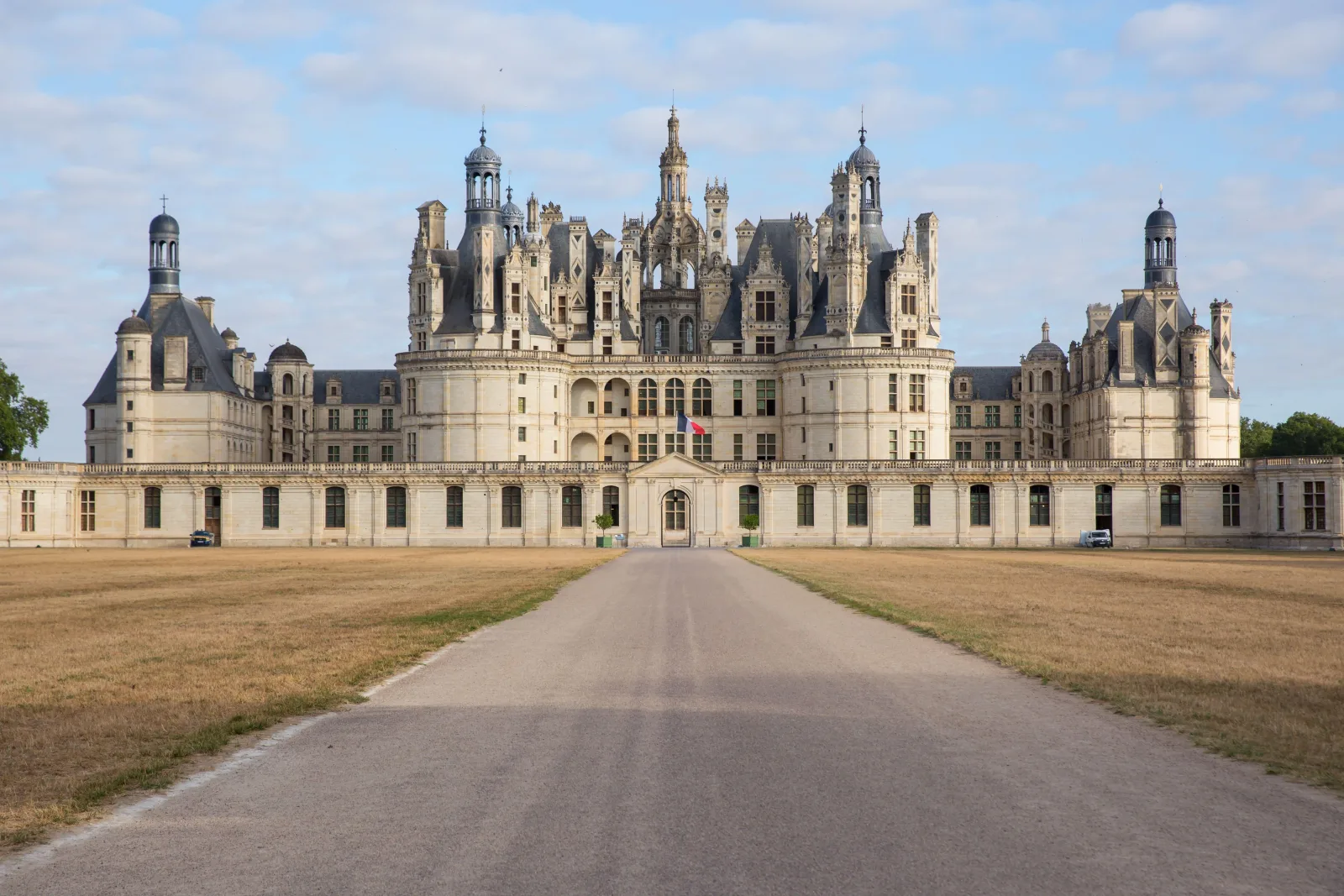 Château de Chambord's west façade seen head-on from the long approach