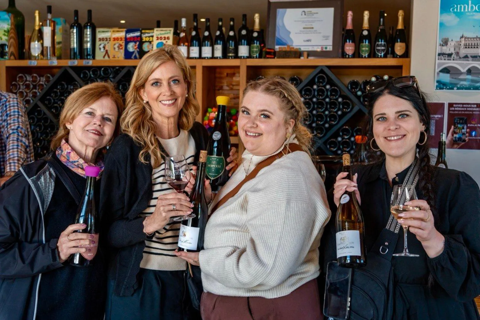 Four guests raising glasses in a Loire Valley tasting room