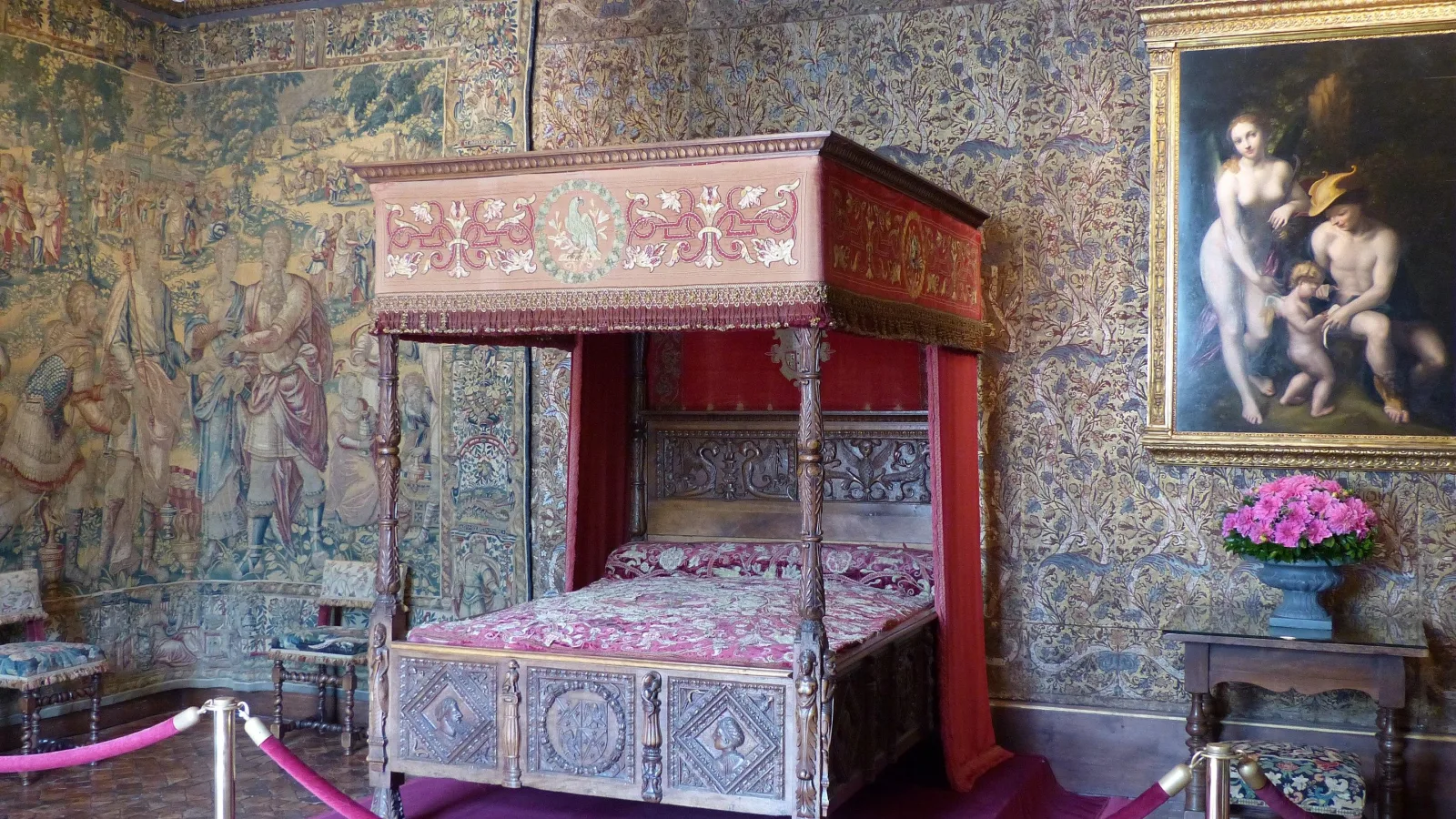 A canopied state bed and tapestries in a Loire Valley château bedroom