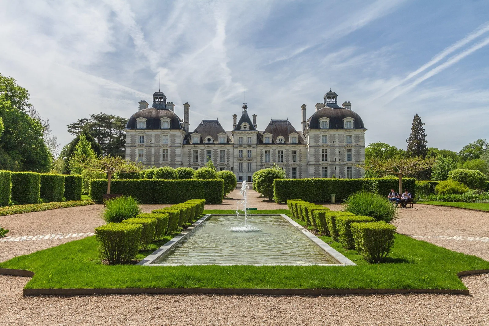 The formal pool and clipped hedges in the gardens at Château de Cheverny