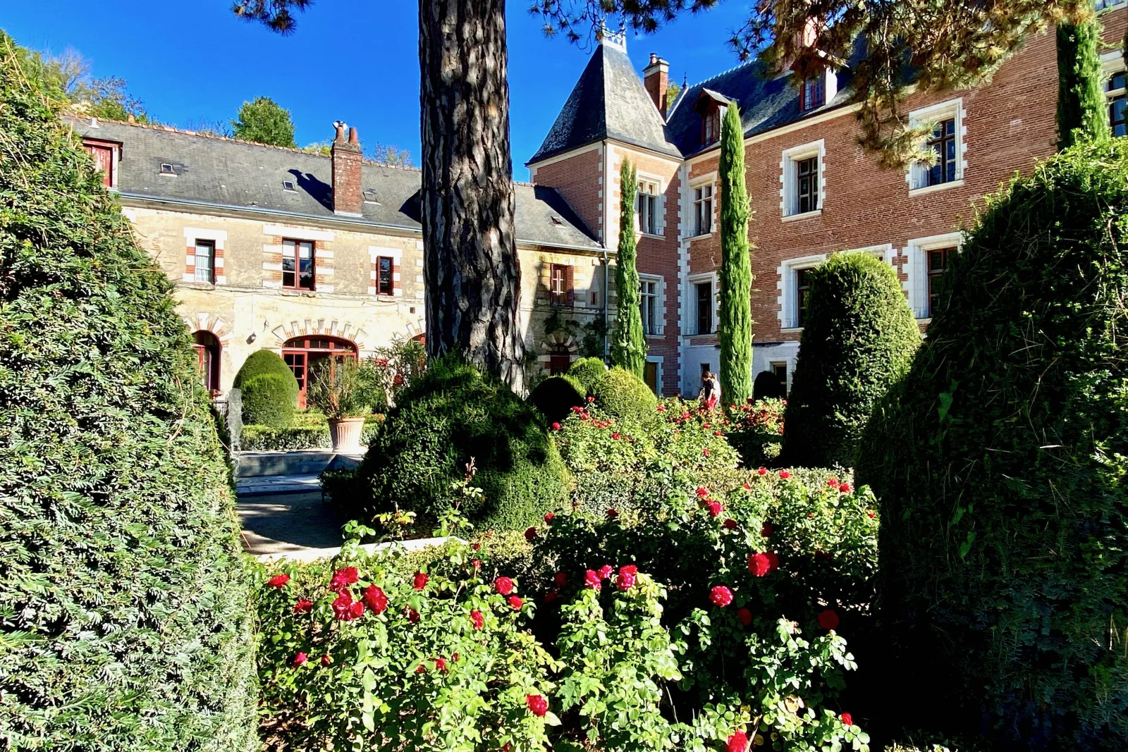 The Château du Clos Lucé manor house behind its summer flower beds