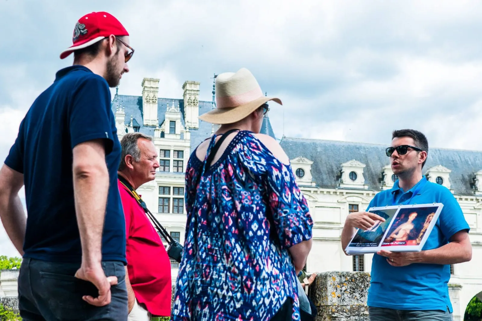 Travellers gathered around their guide outside Château de Chenonceau