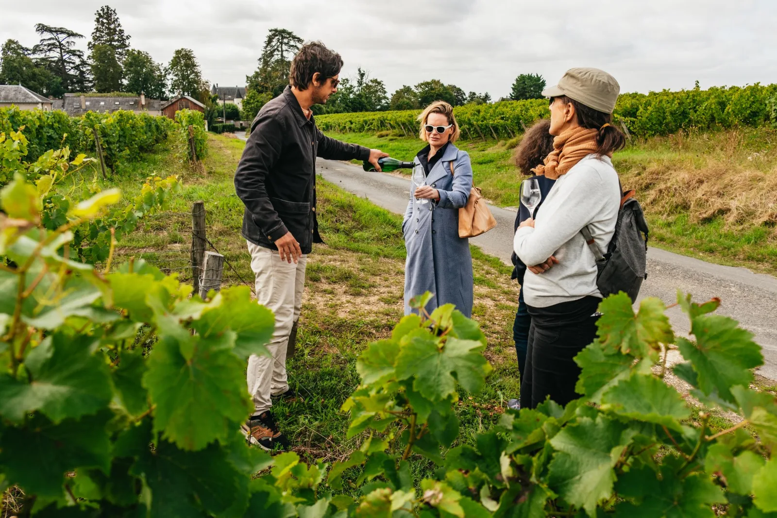 A winegrower explaining the vines to guests in a Loire Valley vineyard